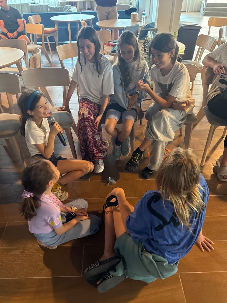 Brittany and children sitting together in a circle, mid-session