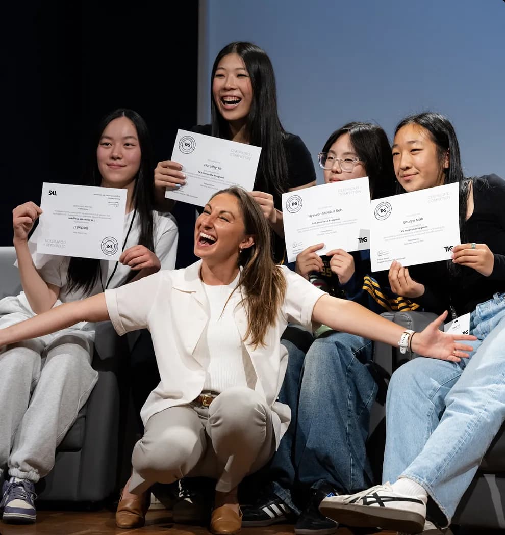 TKS students celebrating on stage with their certificates