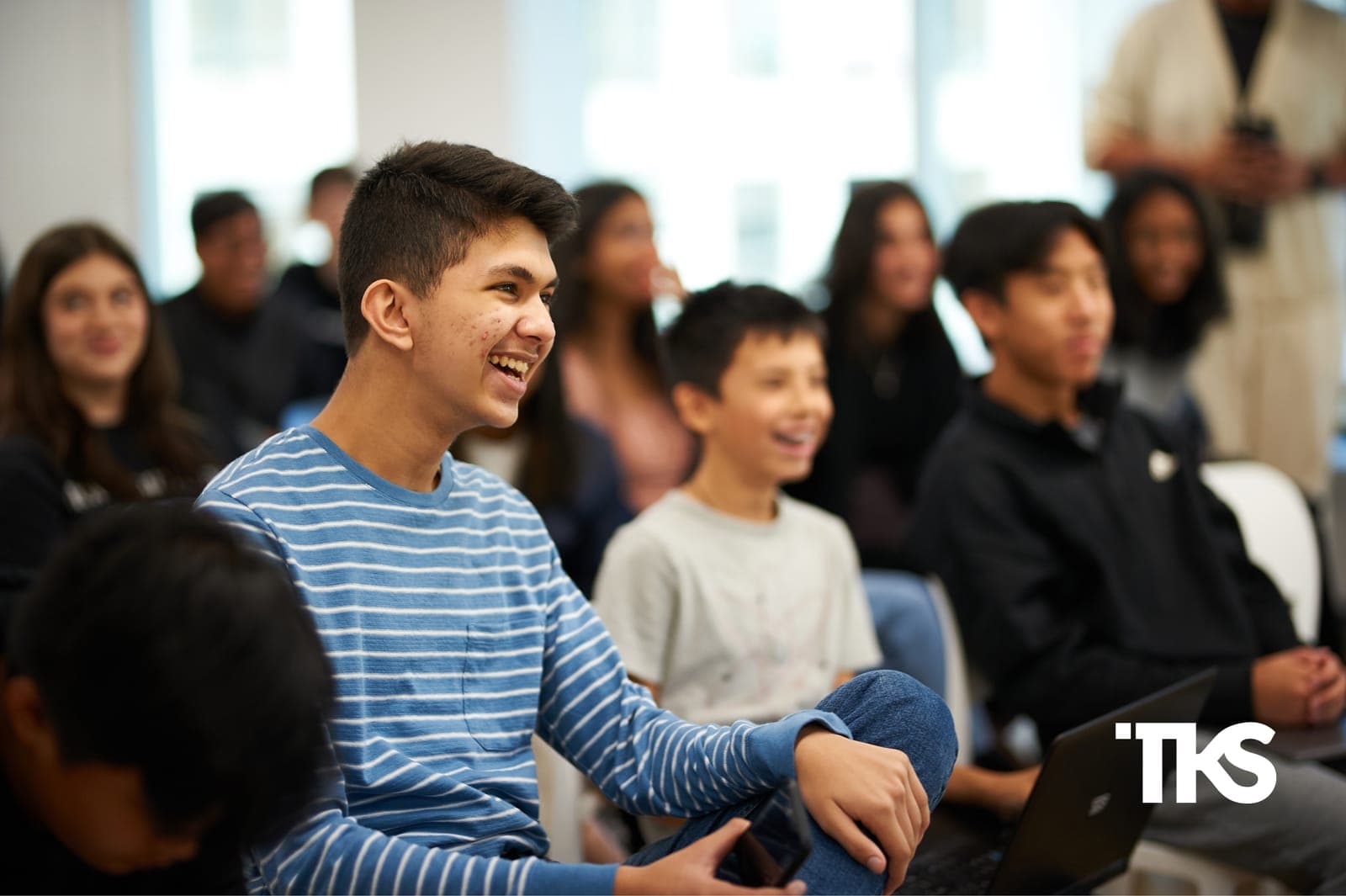 Teenagers laughing together during a TKS hub cohort session